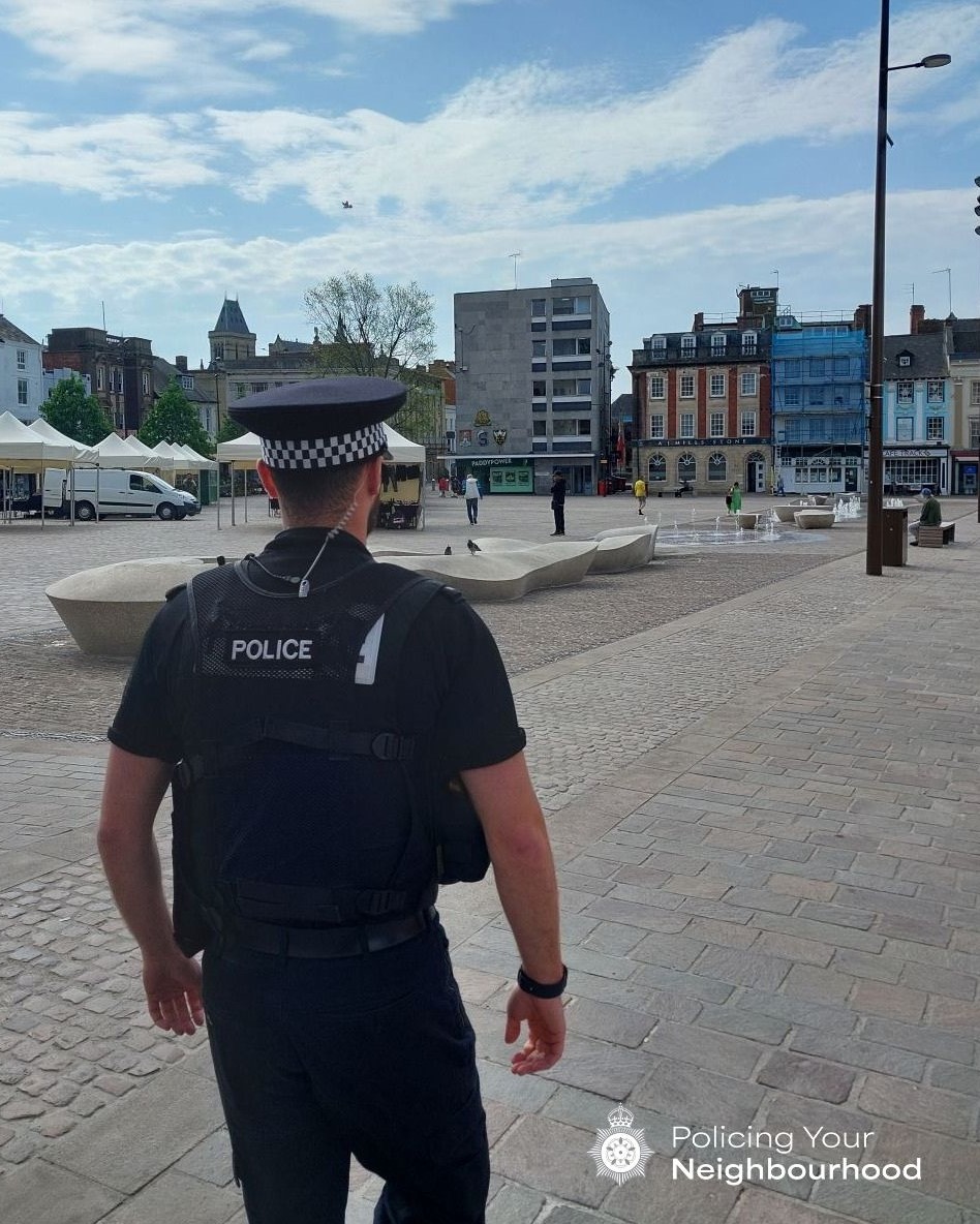 A uniformed police officer on patrol in Northampton market square